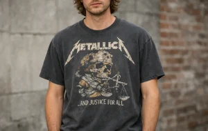 Model wearing a faded 90s vintage band tee with cracked graphic print in an editorial street-style setting.